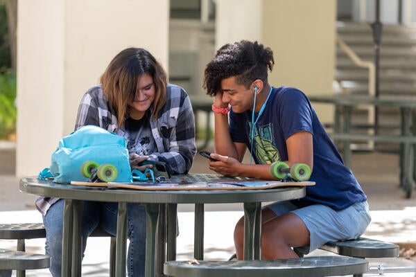 UCR students sitting at an exterior table