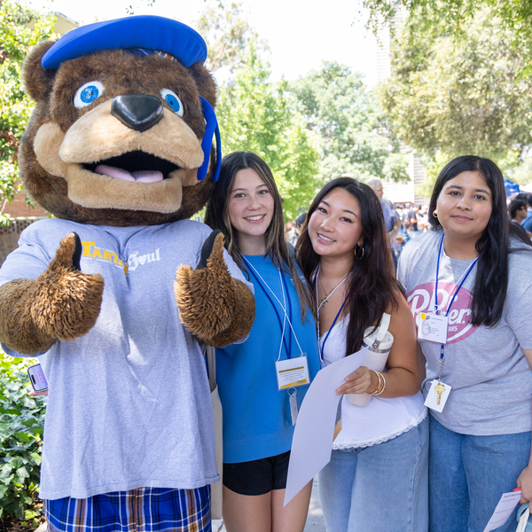 UCR Scotty mascot standing with students outdoors
