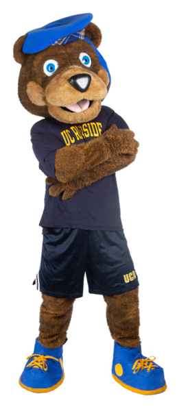 Scotty the bear mascot standing with his arms crossed